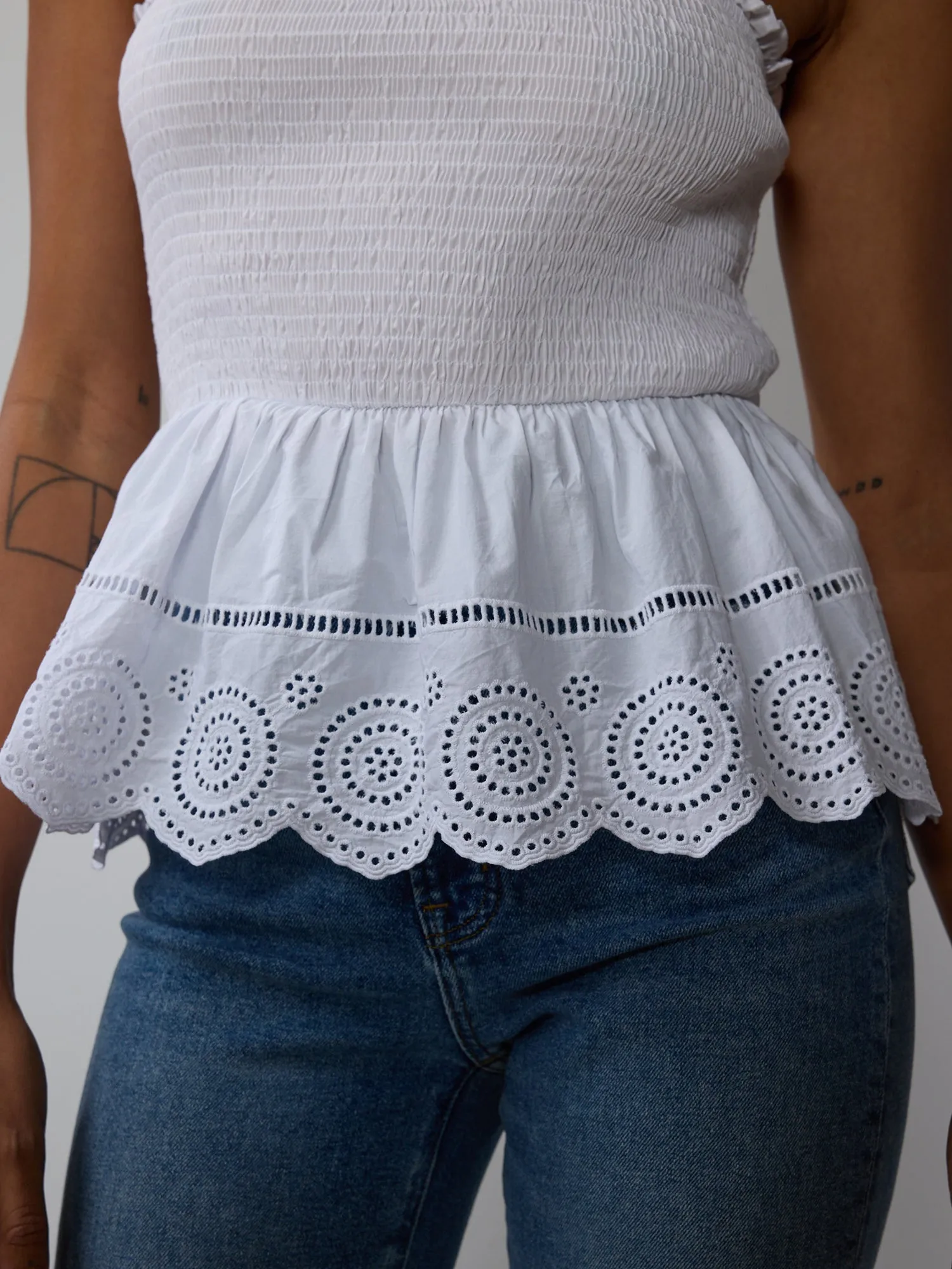 Smocked Eyelet Peplum Top